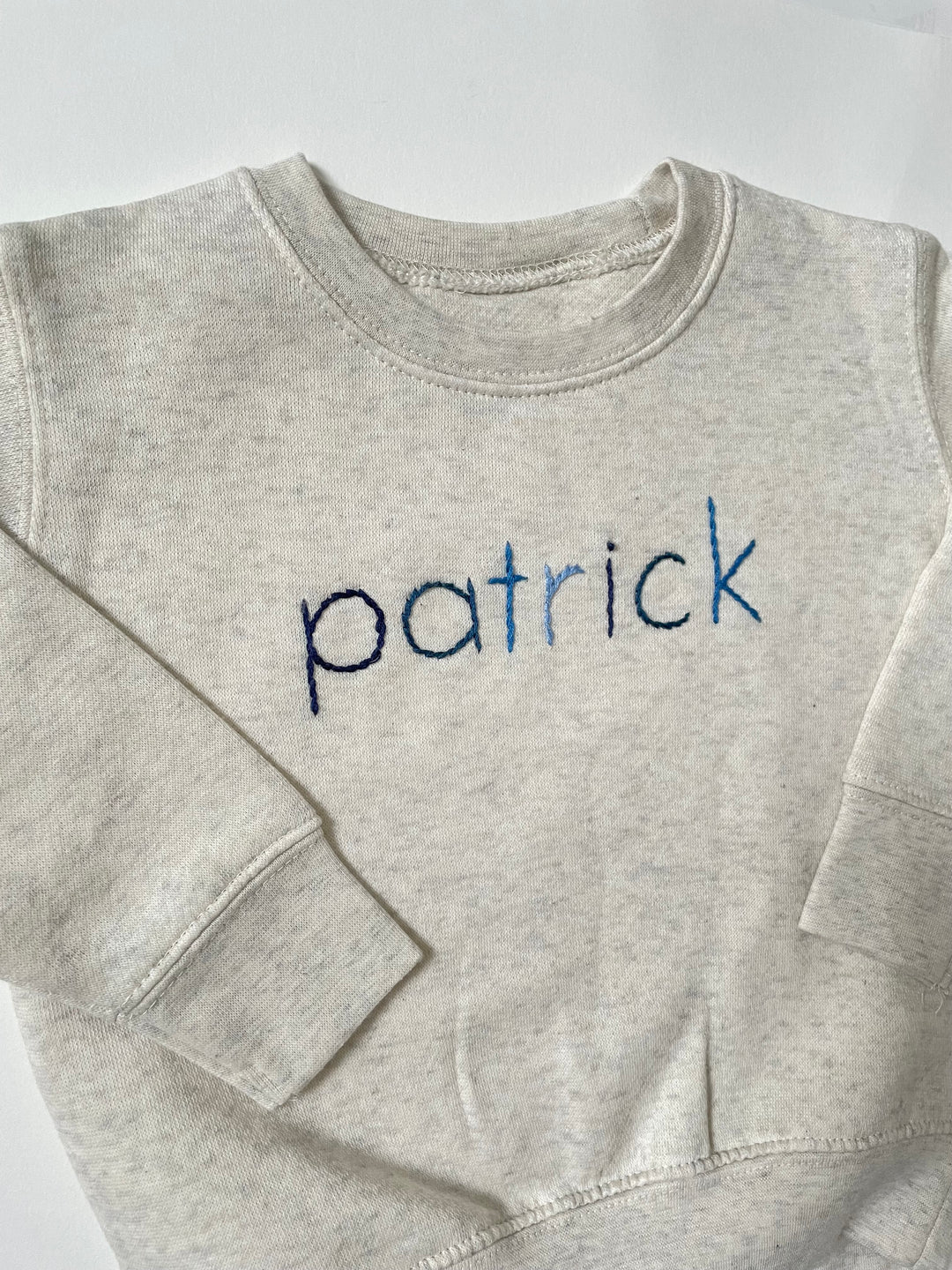 Cream Sweatshirt with custom name in alternating blue thread