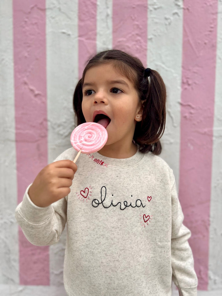 Cream sweatshirt with personalized name and hearts.  Hand embroidered.