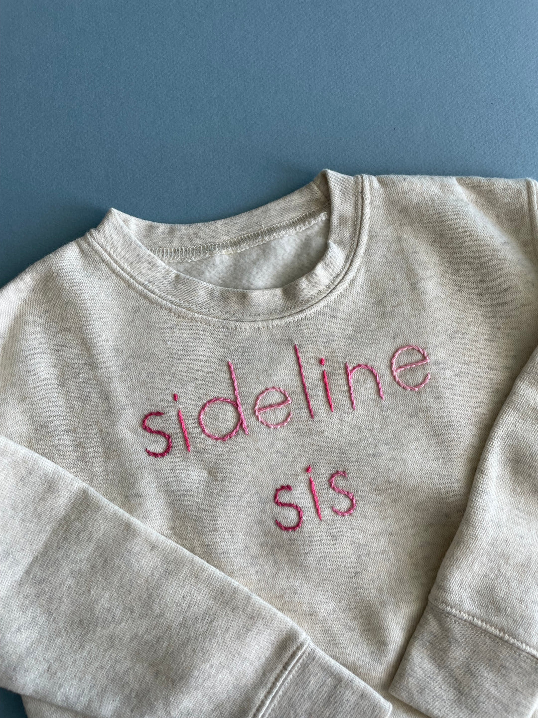 Sideline Sis Cream Sweatshirt hand embroidered in ombre pink thread